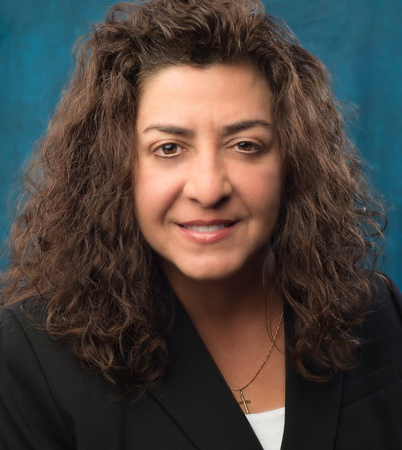 Professional headshot of Diane in office setting